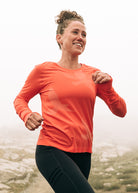 Altitude Long Sleeve in Alpenglow, running on trail